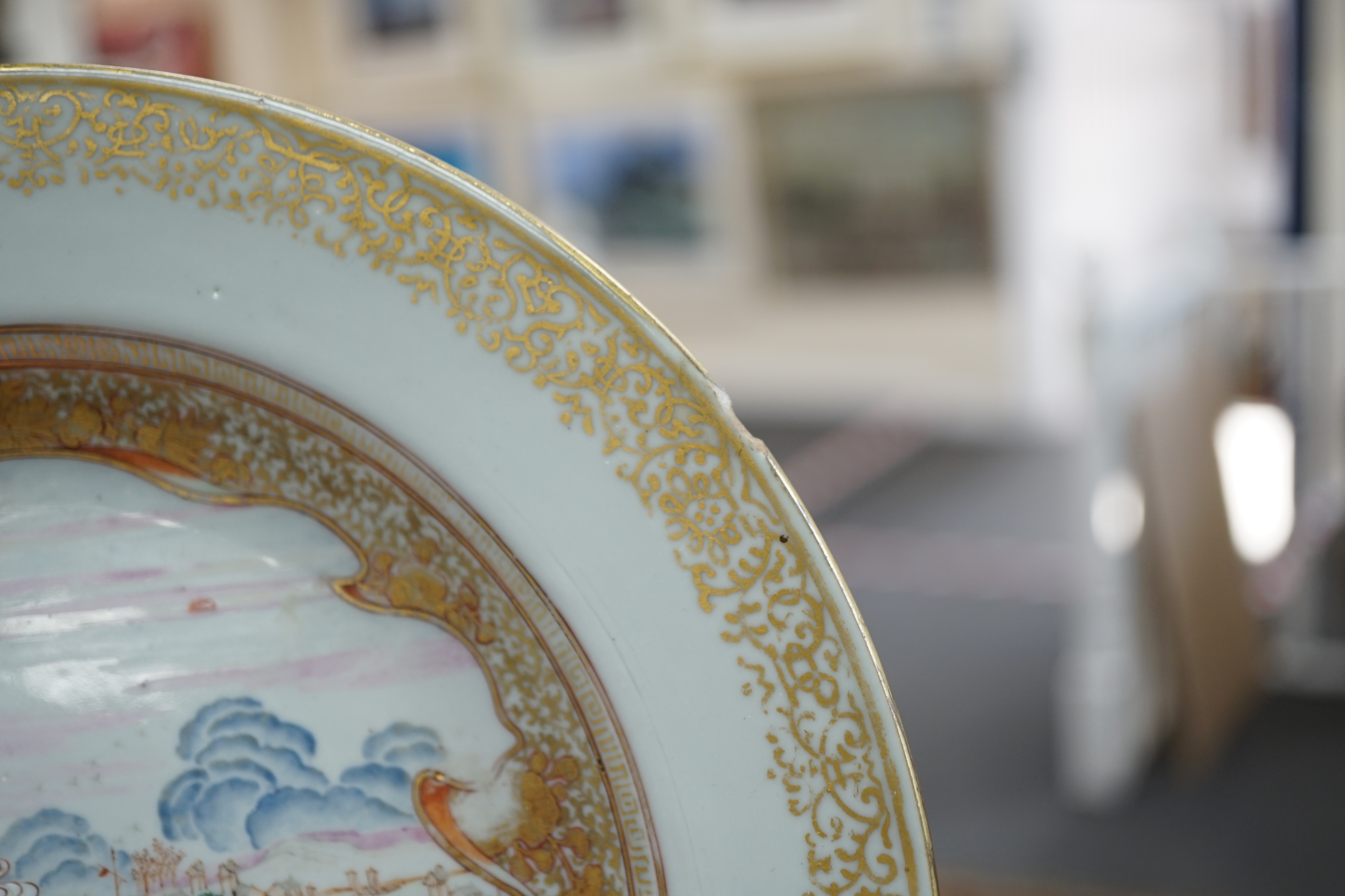A pair of Chinese famille rose ‘landscape’ plates, Yongzheng-Qianlong period, small edge chip